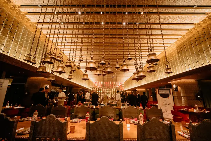 A restaurant hall set for dinner, Aerocity